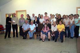 Around 25 people sat in rows watching as the donation is received