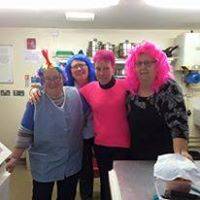 Mavis, Helen, Bev, and Ann standing in a group, all with brightly-coloured wigs or dyed hair.